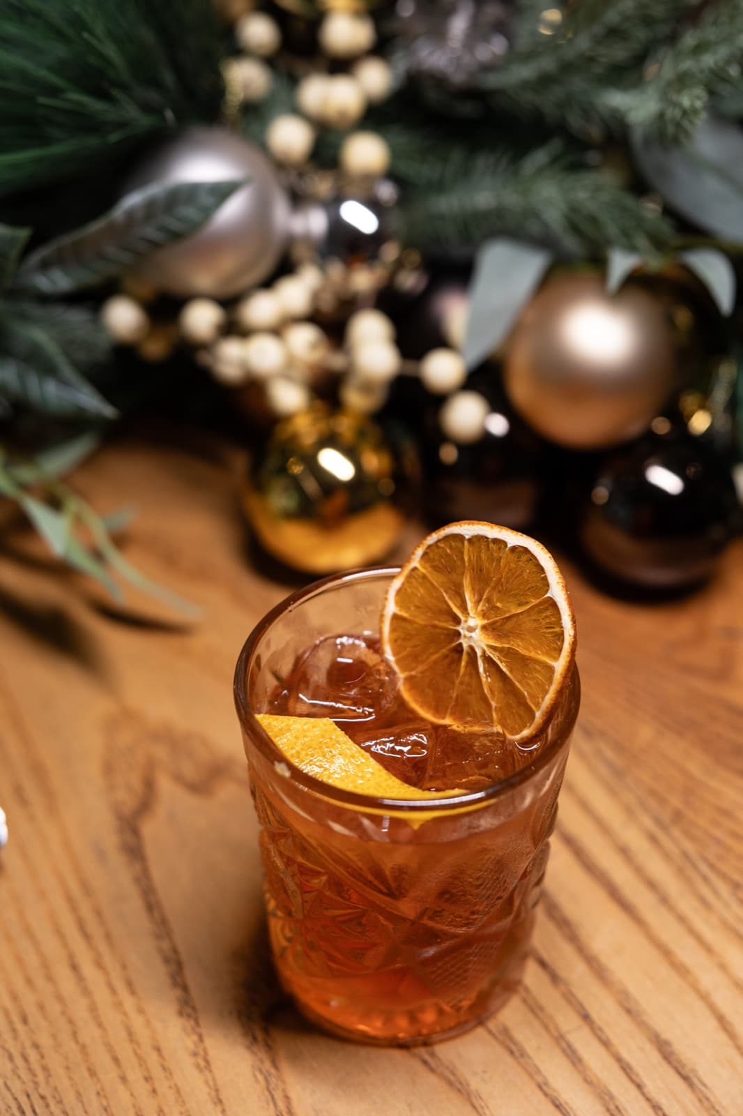 Amber Christmas cocktail with dried orange